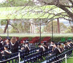 Sitting and waiting in the back row.